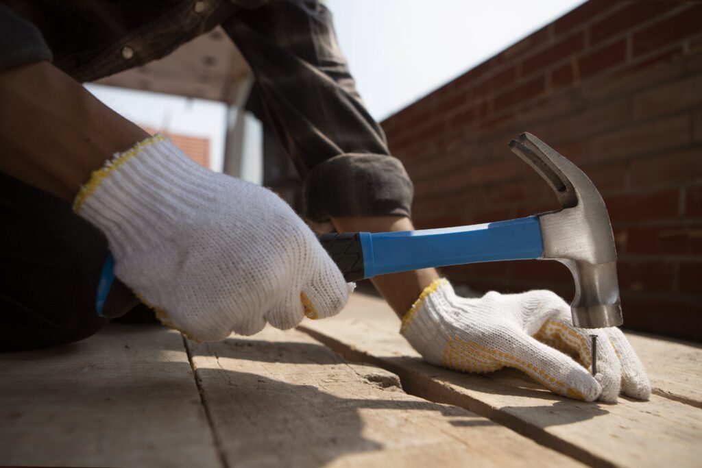 construction-worker-using-hammer-job-site-min