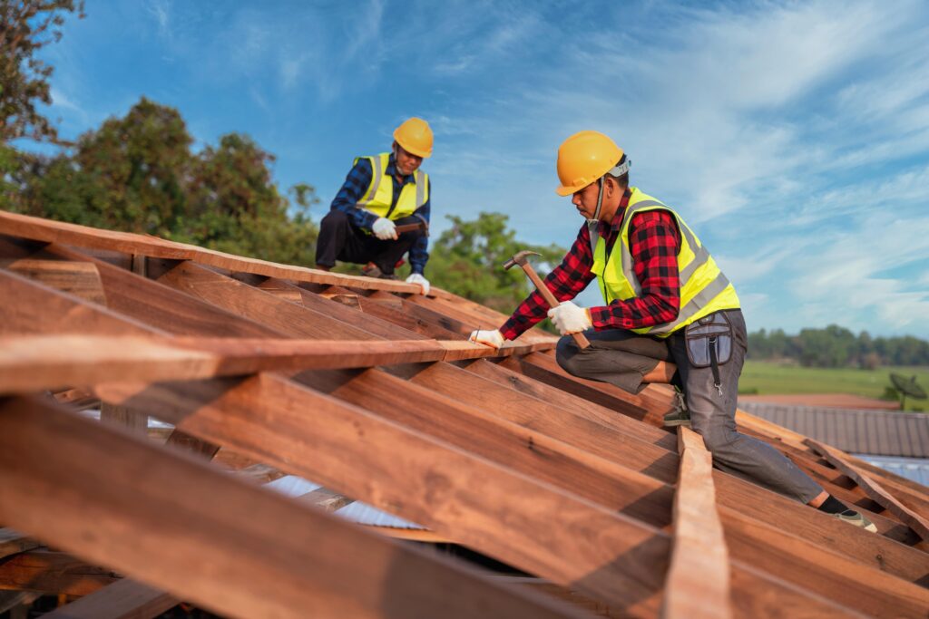 roofer-two-roofer-carpenter-working-roof-structure-construction-site-teamwork-construction-concept-min